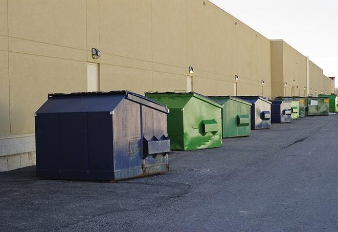 a crowd of dumpsters of all colors and sizes at a construction site in Arabi LA